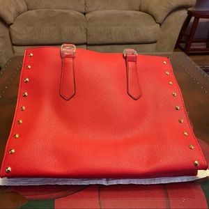 Bright red shoulder tote with gold stud trim.